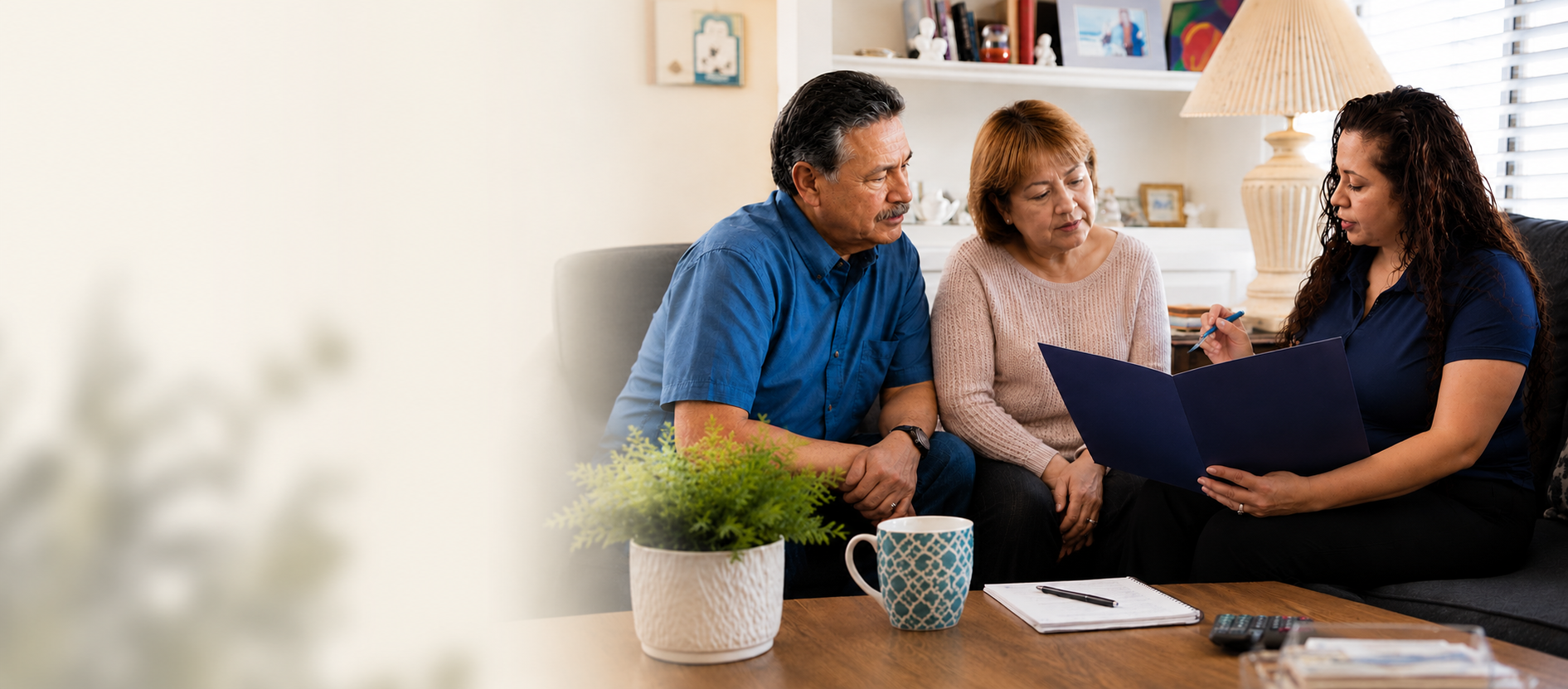 Advisor discussing documents with an elderly couple at home